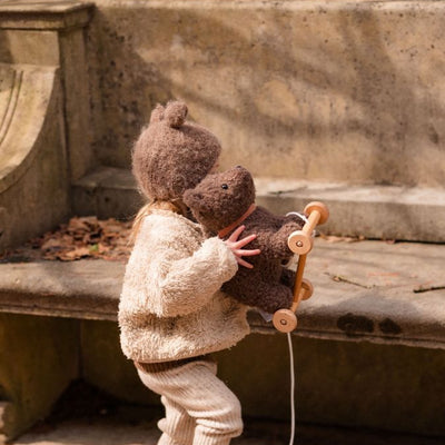 Toddler hugging bear