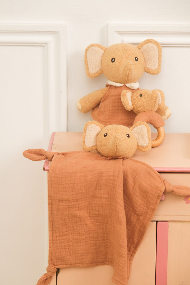 Ollie elephant doudou and rattle styled on dresser