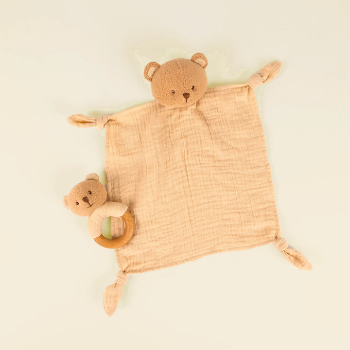 Marcel bear doudou and rattle on pale sand