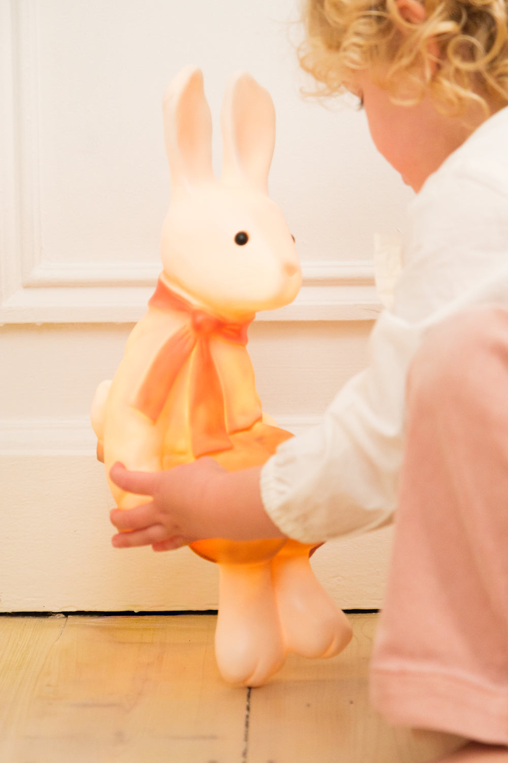 Lenny the Rabbit night lamp held by a child