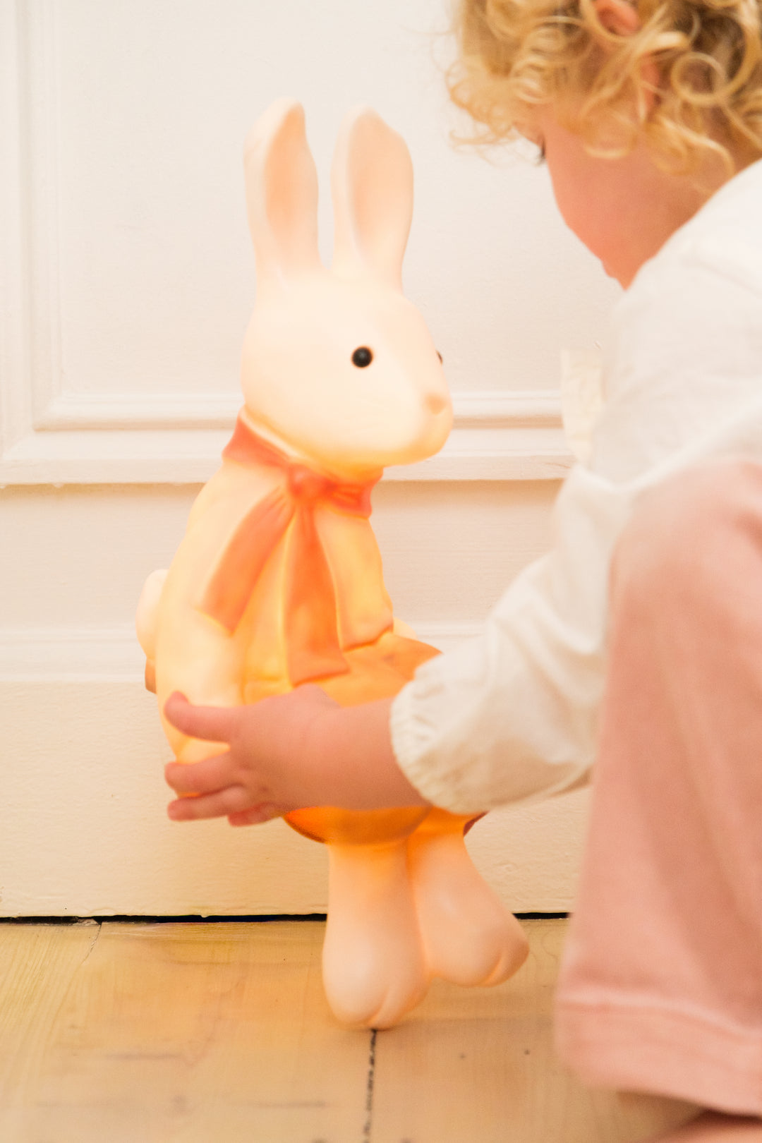 Lenny the Rabbit night lamp held by a child