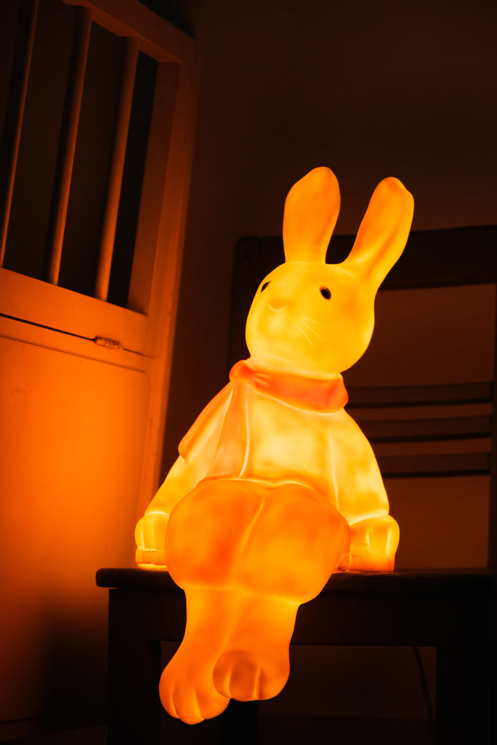 Lenny the Rabbit night lamp three-quarter view glowing warm