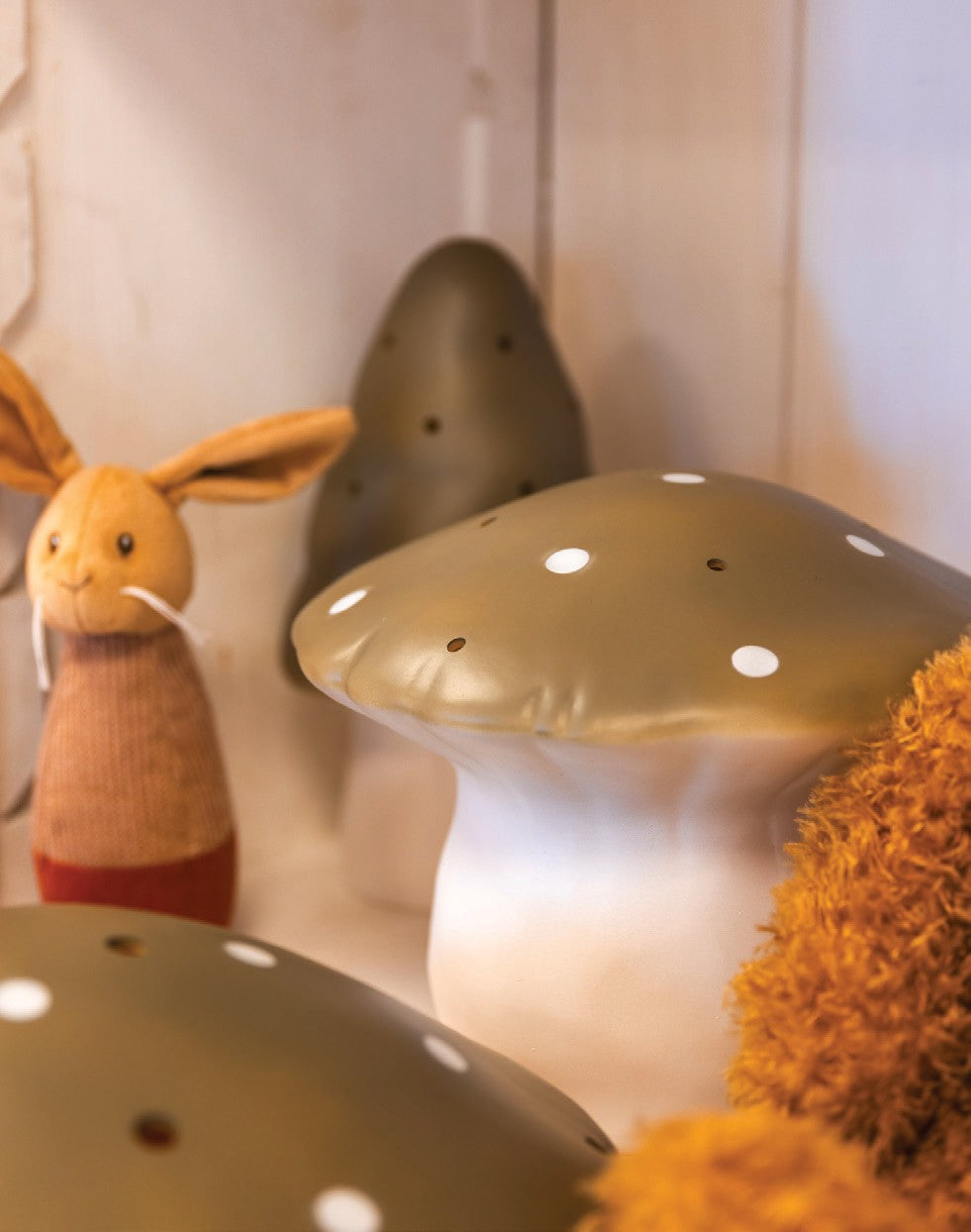 Medium and small mushroom night lamps in Bronze Brown on a shelf