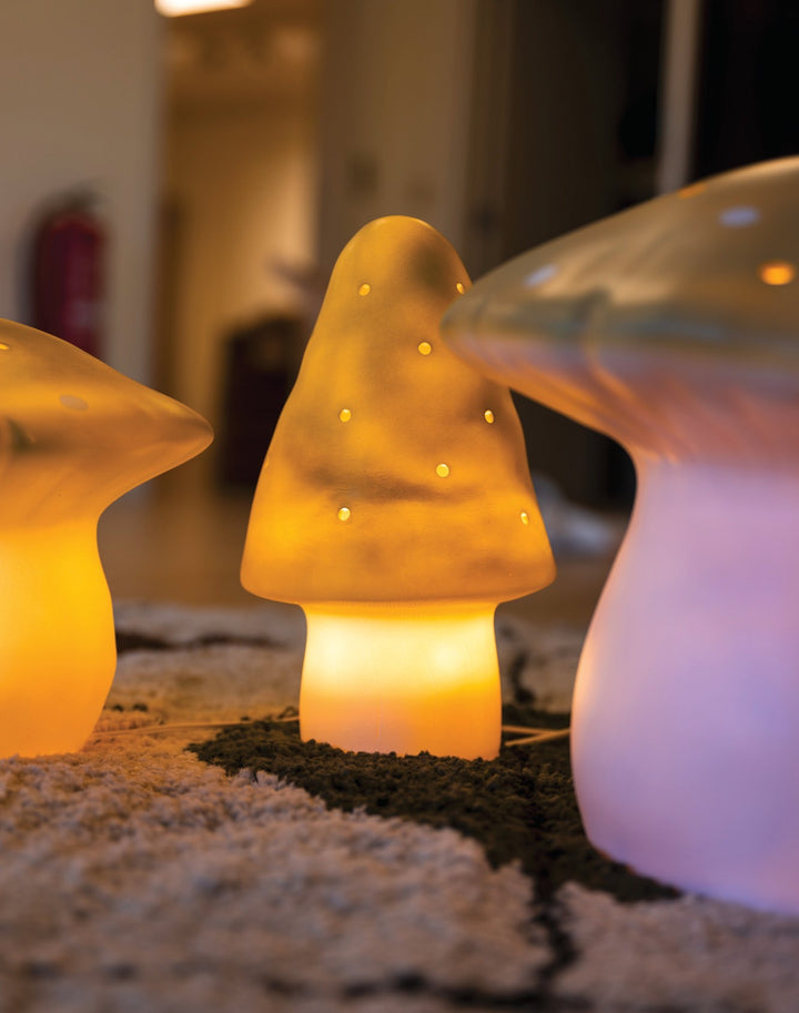 Mushroom night lamps in Lemongrass, lit in a dark room