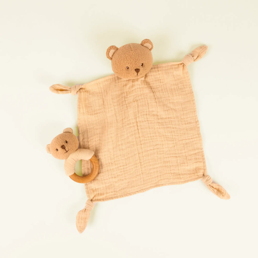 Marcel bear doudou and rattle on pale sand