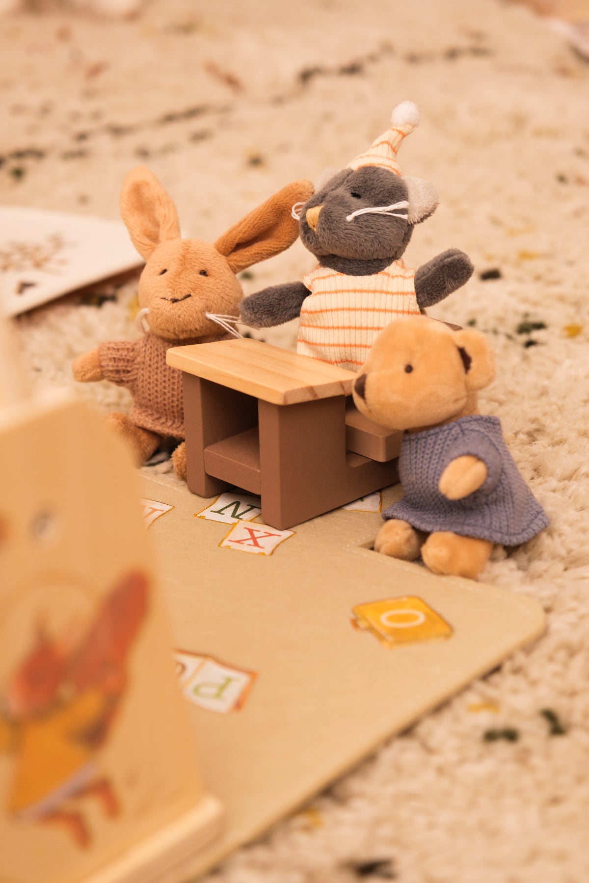 Miniature friends at school desk