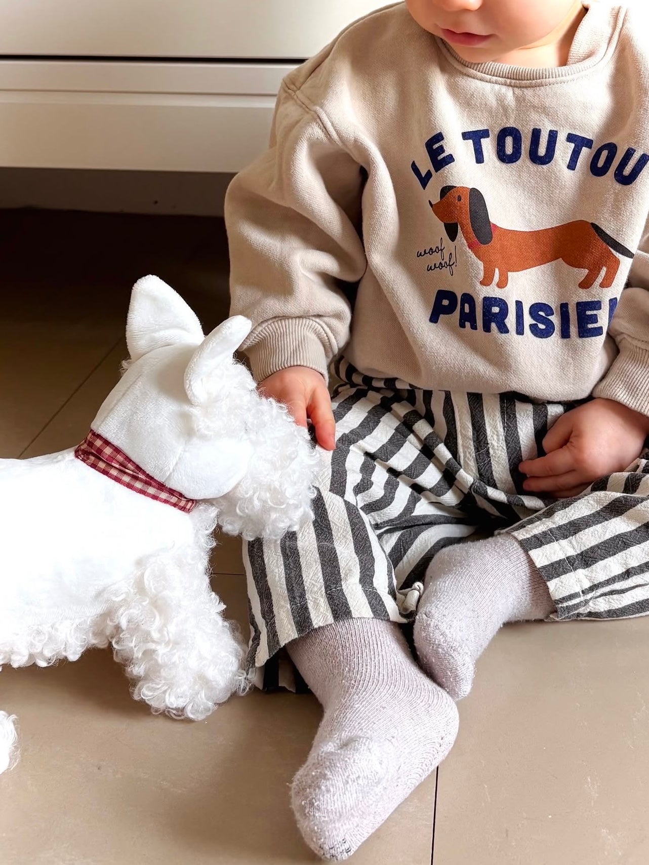 Toddler with pull-along lamb