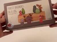 FOREST ANIMALS IN A LOG